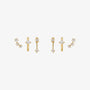 A set of three gold-toned ear cuff earrings with clear gemstones, arranged horizontally on a plain white background.